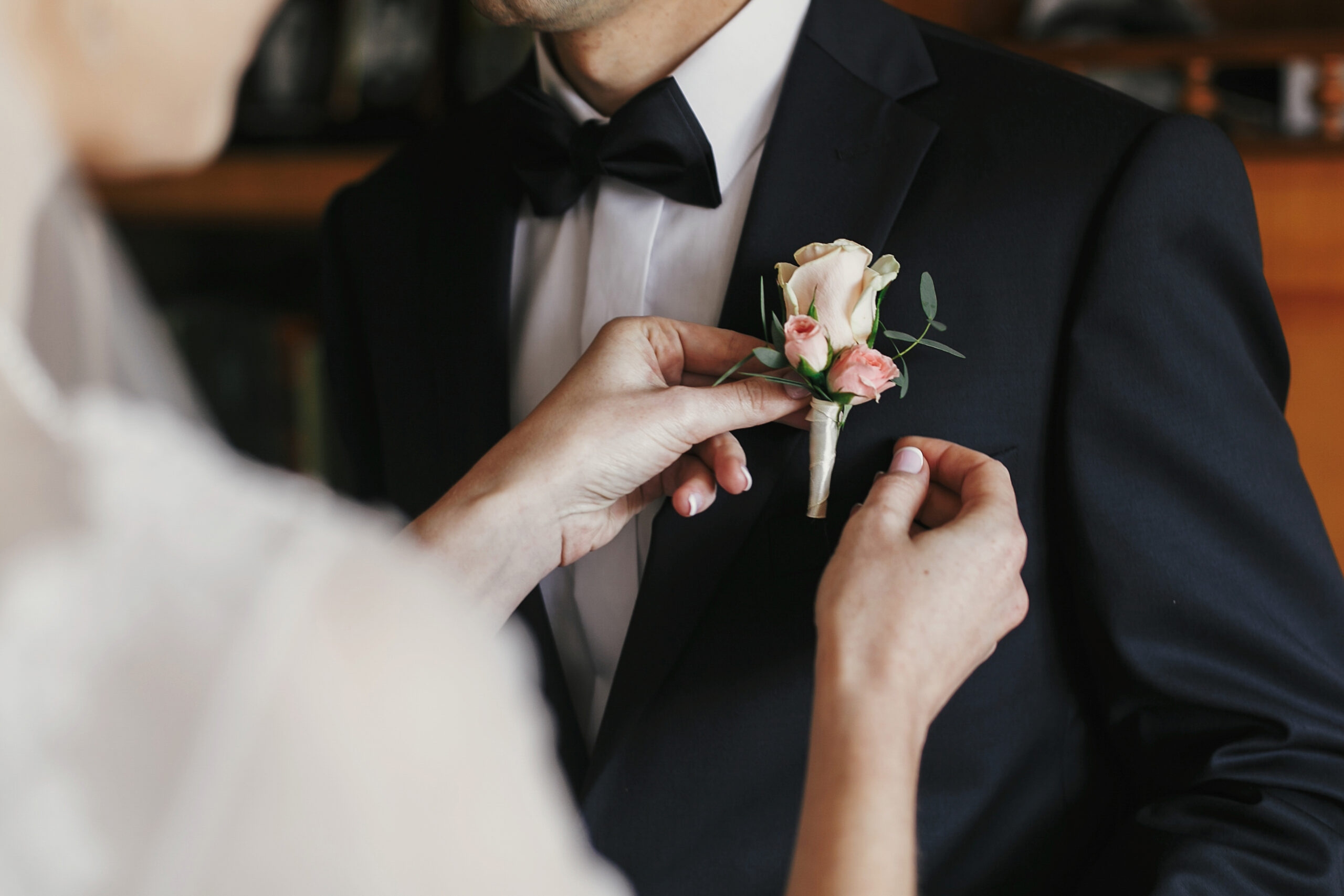 Beautiful,Bride,Putting,On,Stylish,Simple,Boutonniere,With,Roses,On
